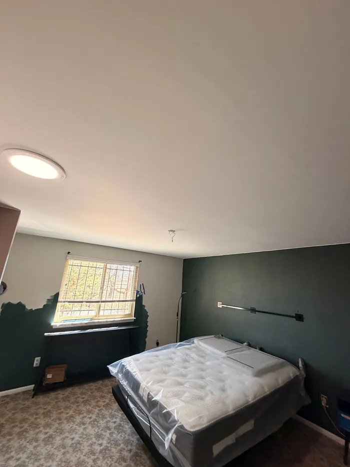 Same bedroom with a smooth finished ceiling