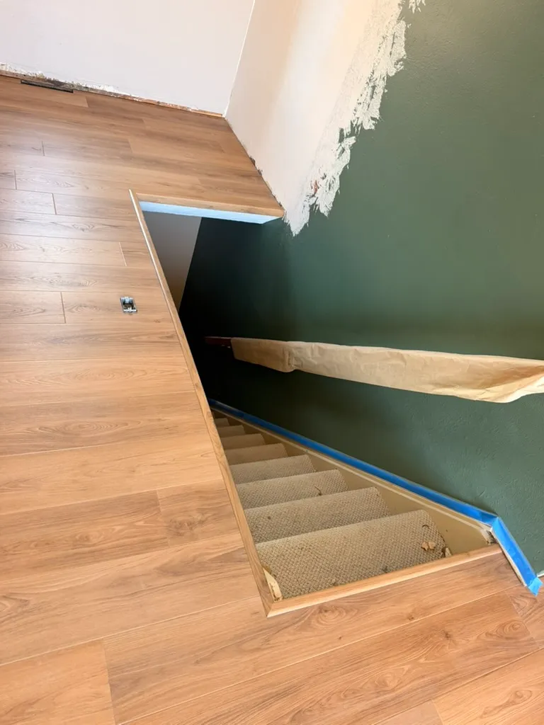 Vinyl plank flooring finished at the top of a stairwell