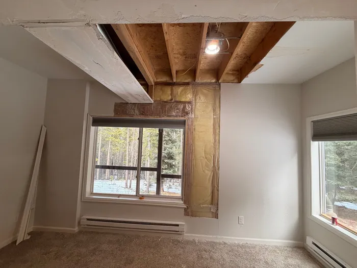 Ceiling opened up to the joists with insulation exposed